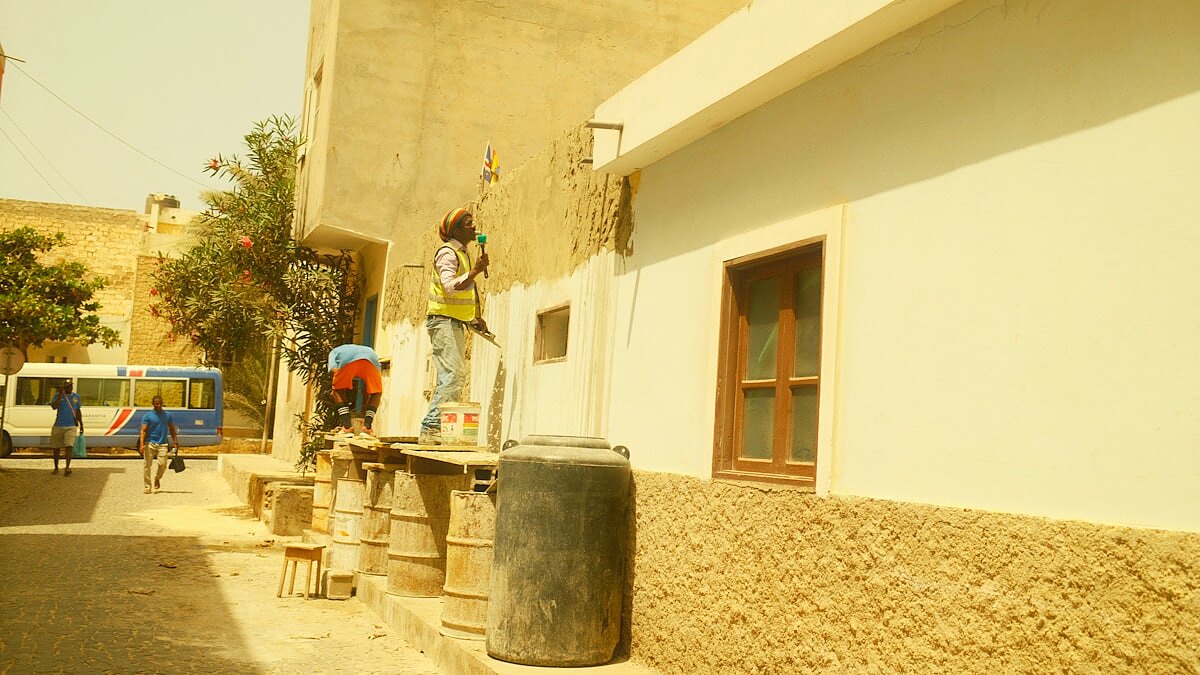 Tradesman applying external render to an exterior building wall from scaffold