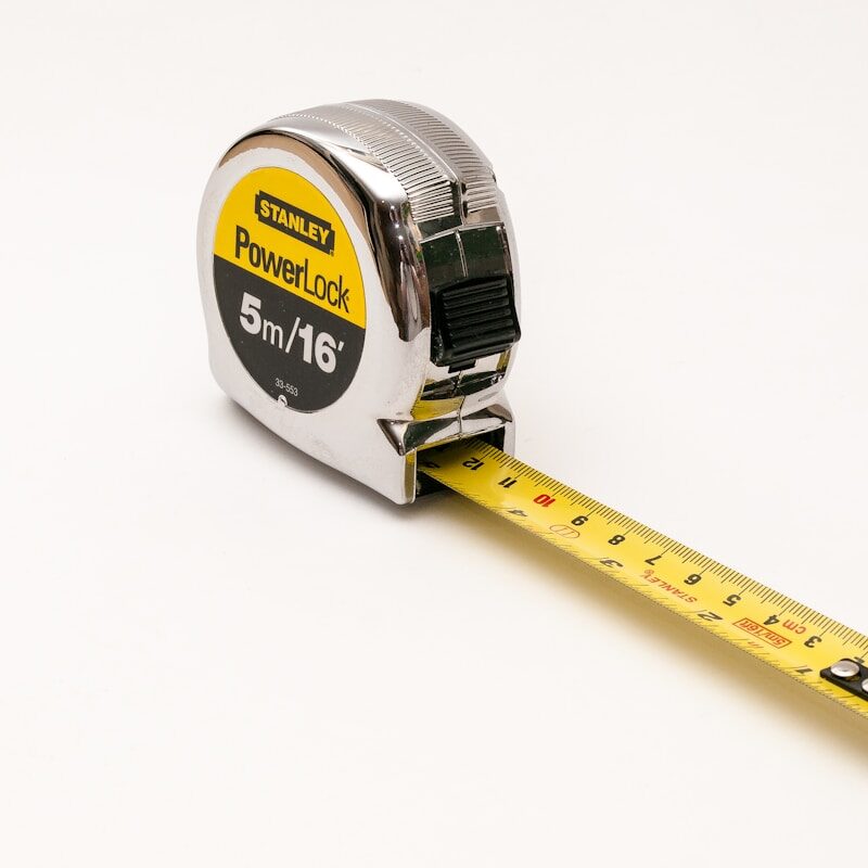 Detail of a tape measure extended across a work surface
