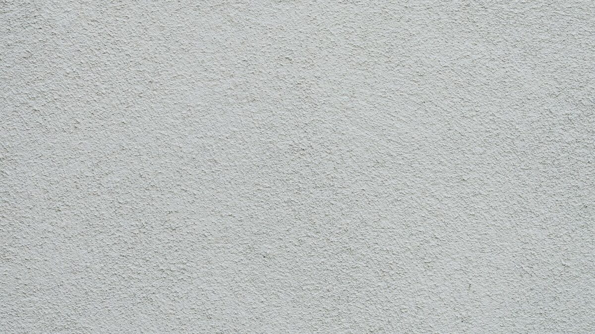 Flat smooth grey wall surface finished evenly after plastering renovation